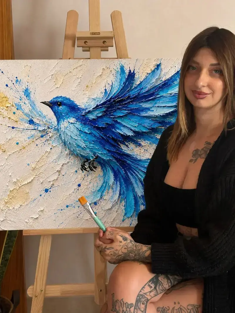 Diana, textured art teacher, next to one of her 3D bird paintings